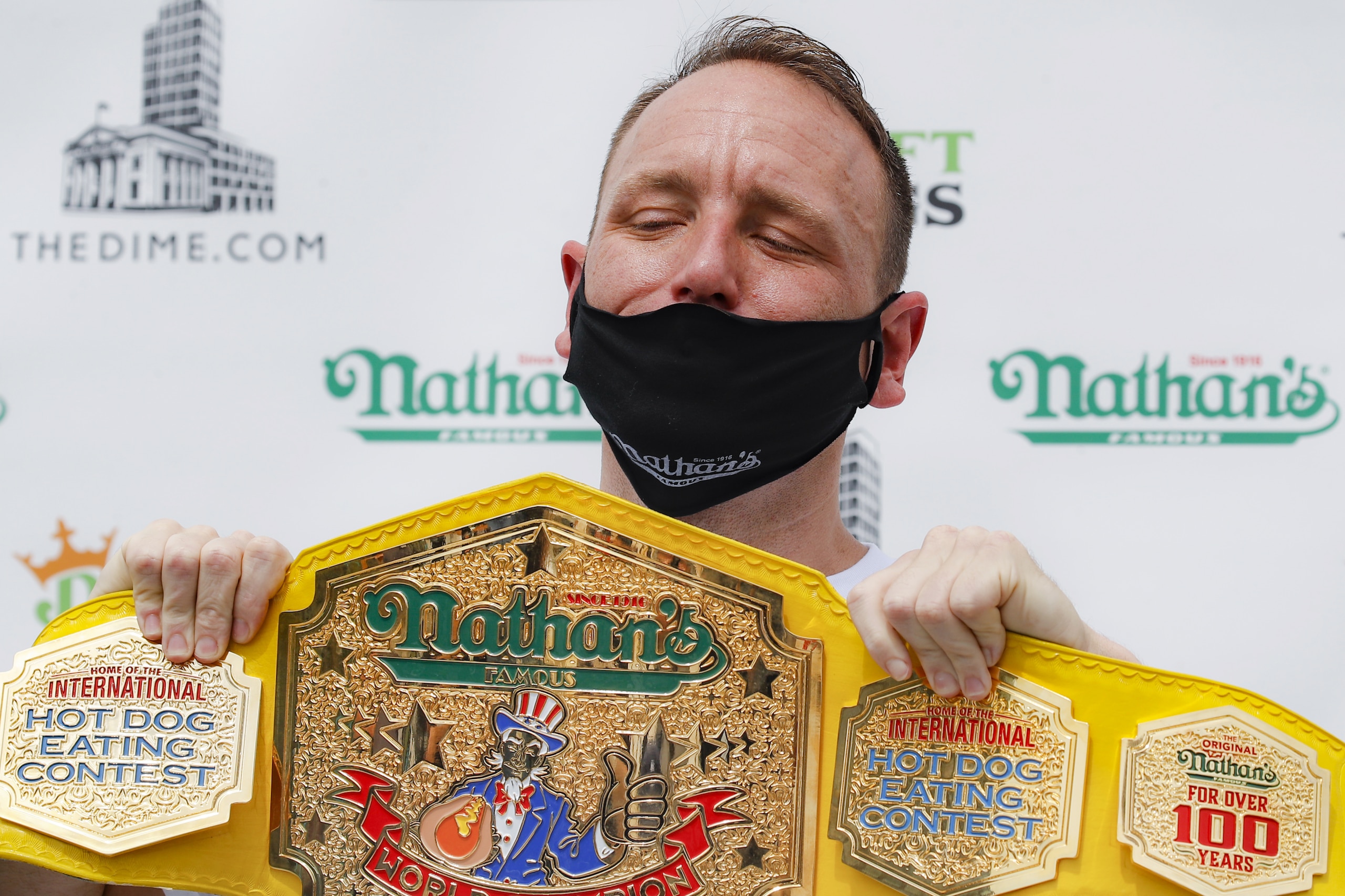 Competitive eater Joey Chestnut holds his championship belt during a weigh-in before the Nathan's Famous July Fourth hot dog eating contest, Friday, July 3, 2020, in the Brooklyn borough of New York. The weigh-in was held in a private, socially-distanced ceremony in the Williamsburg neighborhood due to COVID-19 concerns. (AP Photo/John Minchillo) Competitive eater Joey Chestnut holds his championship belt during a weigh-in before the Nathan's Famous July Fourth hot dog eating contest, Friday, July 3, 2020, in the Brooklyn borough of New York. The weigh-in was held in a private, socially-distanced ceremony in the Williamsburg neighborhood due to COVID-19 concerns. (AP Photo/John Minchillo)