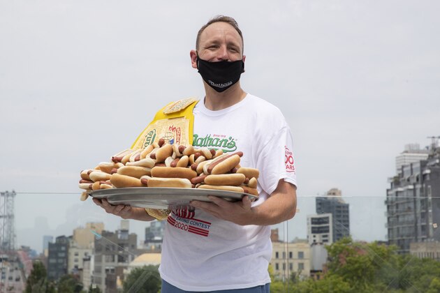 Competitive eater Joey Chestnut poses for a photograph before the Nathan's Famous July Fourth hot dog eating contest, Friday, July 3, 2020, in the Brooklyn borough of New York. The weigh-in was held in a private, socially-distanced ceremony in the Williamsburg neighborhood due to COVID-19 concerns. (AP Photo/John Minchillo)