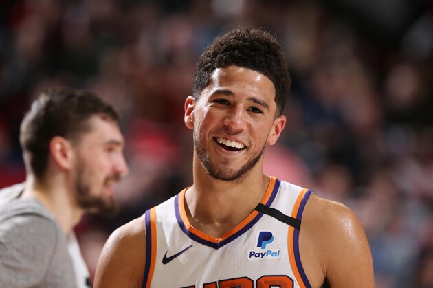 PORTLAND, OR - MARCH 10: Devin Booker #1 of the Phoenix Suns smiles during the game on March 10 , 2020 at the Moda Center Arena in Portland, Oregon. NOTE TO USER: User expressly acknowledges and agrees that, by downloading and or using this photograph, user is consenting to the terms and conditions of the Getty Images License Agreement. Mandatory Copyright Notice: Copyright 2020 NBAE (Photo by Sam Forencich/NBAE via Getty Images)
