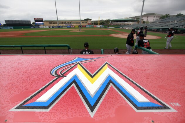 The new Miami Marlins logo is seen over their dugout during an intrasquad spring training baseball game Sunday, March 4, 2012, in Jupiter, Fla. (AP Photo/Jeff Roberson)