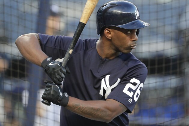 New York Yankees' Andrew McCutchen (26) waits to hit in the batting cage before Game 4 of baseball's American League Division Series against the Boston Red Sox, Tuesday, Oct. 9, 2018, in New York. (AP Photo/Frank Franklin II)