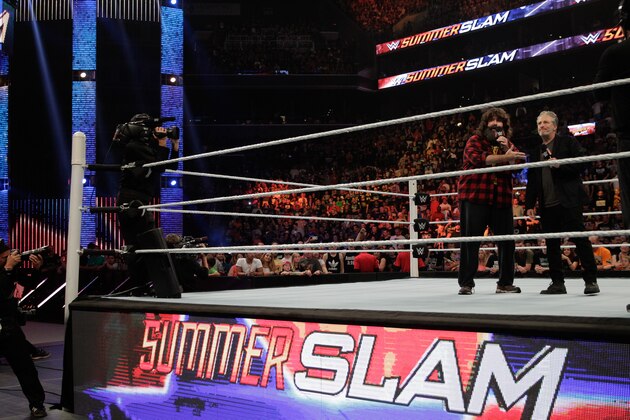 NEW YORK, NY - AUGUST 23: Mick Foley talks with WWE SummerSlam 2015 host Jon Stewart at Barclays Center of Brooklyn on August 23, 2015 in New York City. (Photo by JP Yim/Getty Images) NEW YORK, NY - AUGUST 23: Mick Foley talks with WWE SummerSlam 2015 host Jon Stewart at Barclays Center of Brooklyn on August 23, 2015 in New York City. (Photo by JP Yim/Getty Images)