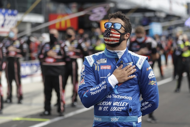 NASCAR Cup Series driver Bubba Wallace (43) stands during the national anthem before a NASCAR auto race at Indianapolis Motor Speedway in Indianapolis, Sunday, July 5, 2020. (AP Photo/Darron Cummings)