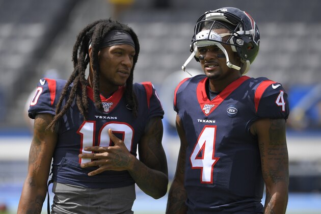 Houston Texans wide receiver DeAndre Hopkins. left, talks with quarterback Deshaun Watson before an NFL football game against the Los Angeles Chargers Sunday, Sept. 22, 2019, in Carson, Calif. (AP Photo/Mark J. Terrill)