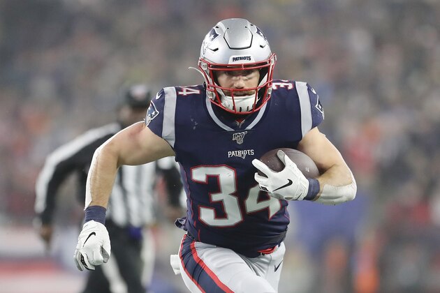 FOXBOROUGH, MASSACHUSETTS - JANUARY 04: Rex Burkhead #34 of the New England Patriots carries the ball against the Tennessee Titans in the second quarter of the AFC Wild Card Playoff game at Gillette Stadium on January 04, 2020 in Foxborough, Massachusetts. (Photo by Elsa/Getty Images)
