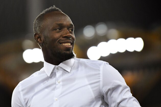 Jamaica's former sprinter Usain Bolt is seen during the athletics women's 200m medal ceremony during the 2018 Gold Coast Commonwealth Games at the Carrara Stadium on the Gold Coast on April 12, 2018. / AFP PHOTO / SAEED KHAN        (Photo credit should read SAEED KHAN/AFP via Getty Images)