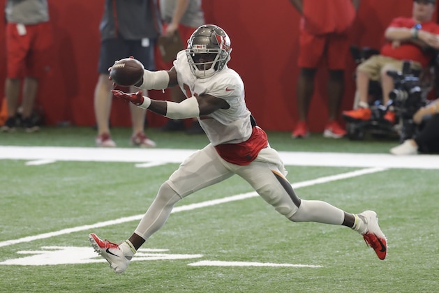 Tampa Bay Buccaneers wide receiver Chris Godwin (12) makes a catch during an NFL football training camp practice Sunday, July 28, 2019, in Tampa, Fla. (AP Photo/Chris O'Meara)