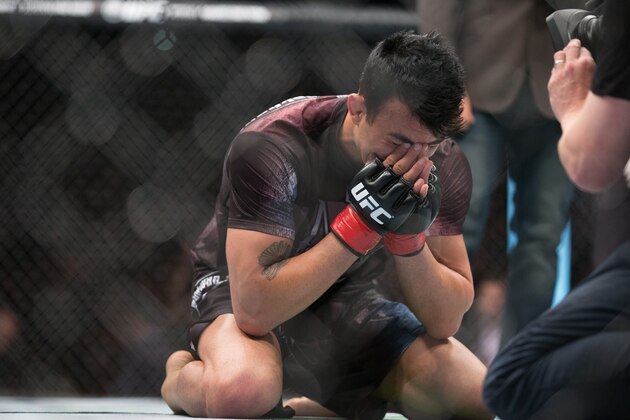 In this photo made available Sunday, June 21, 2015, Finland's Makwan Amirkhani cries after wining against Mexico's Masio Fullenduring their bout at UFC Fight Night in Berlin, Germany, Saturday, June 20, 2015. Amirkhani defeated Fullen in 1 round. (AP Photo/Axel Schmidt)