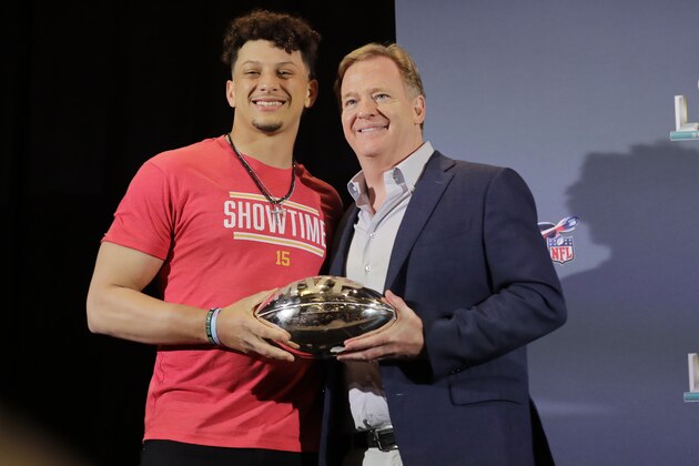 Kansas City Chiefs quarterback Patrick Mahomes (15) poses with NFL Commissioner Roger Goodell, before Mahomes speaks during a news conference on Monday, Feb. 3, 2020, in Miami after winning the NFL Super Bowl 54 football game. (AP Photo/Brynn Anderson)