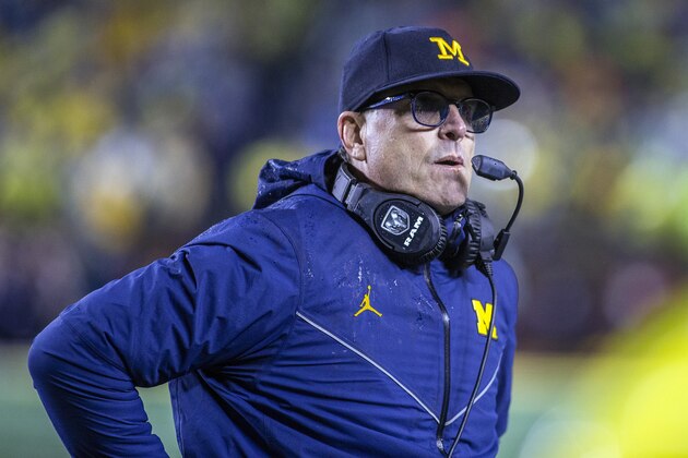 Michigan head coach Jim Harbaugh wears a headset around his neck, in the third quarter of an NCAA college football game against Notre Dame in Ann Arbor, Mich., Saturday, Oct. 26, 2019. Michigan won 45-14. (AP Photo/Tony Ding)