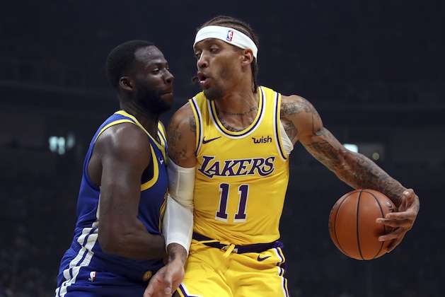 Los Angeles Lakers' Michael Beasley, right, drives the ball as Golden State Warriors' Draymond Green defends during the first half of a preseason NBA basketball game Friday, Oct. 12, 2018, in San Jose, Calif. (AP Photo/Ben Margot)