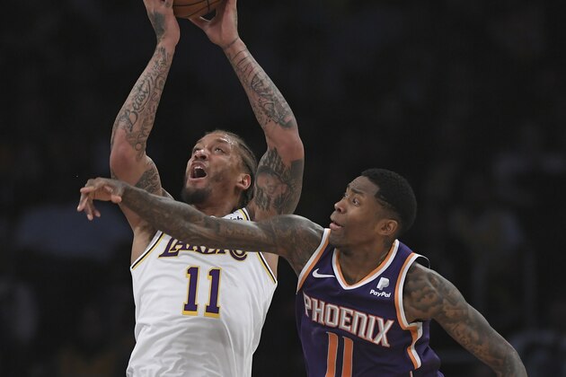 LOS ANGELES, CA - JANUARY 27: Michael Beasley #11 of the Los Angeles Lakers shoots the ball over Jamal Crawford #11 of the Phoenix Suns in the first half at Staples Center on January 27, 2019 in Los Angeles, California. NOTE TO USER: User expressly acknowledges and agrees that, by downloading and or using this photograph, User is consenting to the terms and conditions of the Getty Images License Agreement. (Photo by John McCoy/Getty Images)