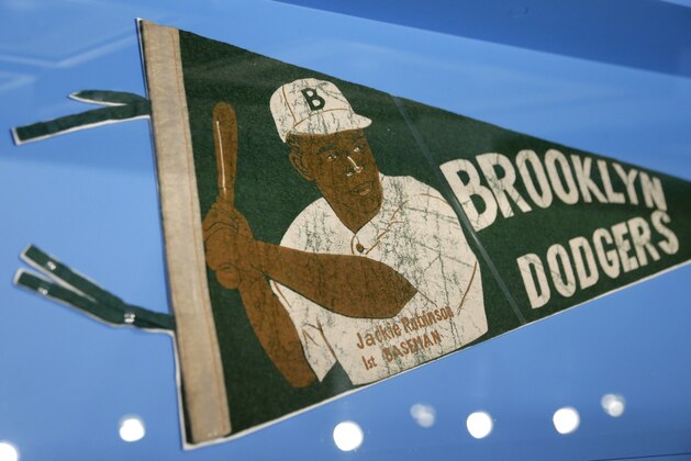 In this In this Tuesday, Jan. 29, 2019 photo phot,  banner with a picture of Brooklyn Dodgers baseball player Jackie Robinson is displayed at the exhibit