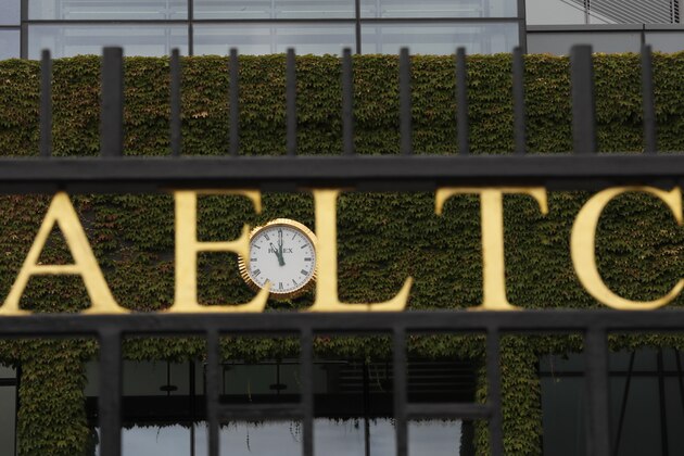 The clock shows 11am, the time play would have started at the All England Lawn Tennis Club in Wimbledon in London, Monday, June 29, 2020. The 2020 Wimbledon Tennis Championships, due to start Monday were cancelled due to the Coronavirus pandemic. (AP Photo/Kirsty Wigglesworth)