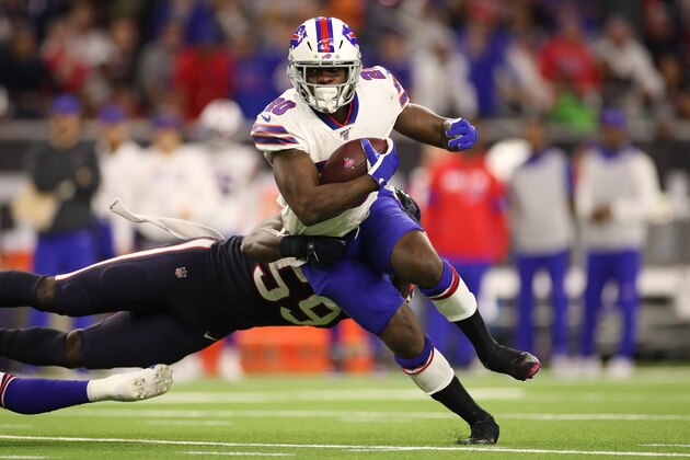 HOUSTON, TEXAS - JANUARY 04:  Frank Gore #20 of the Buffalo Bills runs the ball against Whitney Mercilus #59 of the Houston Texans during the third quarter of the AFC Wild Card Playoff game at NRG Stadium on January 04, 2020 in Houston, Texas. (Photo by Christian Petersen/Getty Images)