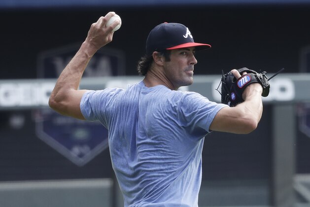 Atlanta Braves' pitcher Cole Hamels throws a ball during a baseball practice at Truist Park on Friday, July 3, 2020, in Atlanta. (AP Photo/Brynn Anderson)