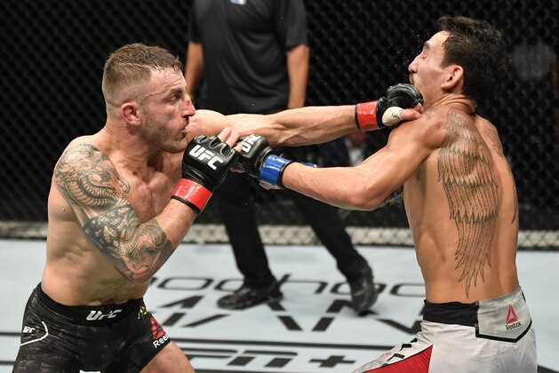 ABU DHABI, UNITED ARAB EMIRATES - JULY 12: (L-R) Alexander Volkanovski of Australia punches Max Holloway in their UFC featherweight championship fight during the UFC 251 event at Flash Forum on UFC Fight Island on July 12, 2020 on Yas Island, Abu Dhabi, United Arab Emirates. (Photo by Jeff Bottari/Zuffa LLC)