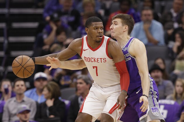 Houston Rockets guard Joe Johnson, left, keeps the ball out of the reach of Sacramento Kings guard Bogdan Bogdanovic during the second half of an NBA basketball game, Wednesday, April 11, 2018, in Sacramento, Calif. The Kings won 96-83. (AP Photo/Rich Pedroncelli)
