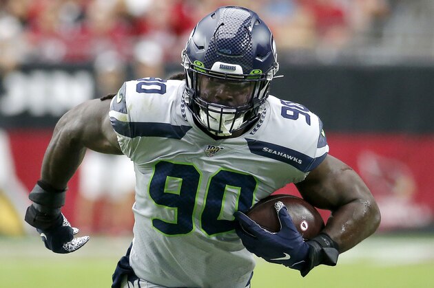 Seattle Seahawks outside linebacker Jadeveon Clowney (90) runs in an interception for a touchdown during the first half of an NFL football game against the Arizona Cardinals, Sunday, Sept. 29, 2019, in Glendale, Ariz. (AP Photo/Rick Scuteri)