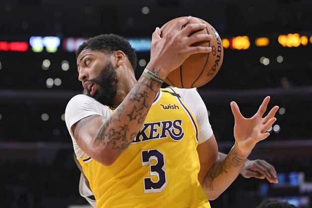 Los Angeles Lakers forward Anthony Davis drives toward the basket during the second half of the team's NBA basketball game against the Memphis Grizzlies on Friday, Feb. 21, 2020, in Los Angeles. The Lakers won 117-105. (AP Photo/Mark J. Terrill)