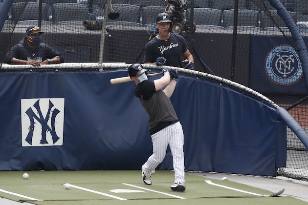 New York Yankees hitting coach Marcus Thames, left, and Aaron Judge, right, watch Clint Frazier bat in the cage during a summer training camp workout, Wednesday, July 8, 2020, at Yankee Stadium in New York. (AP Photo/Kathy Willens)
