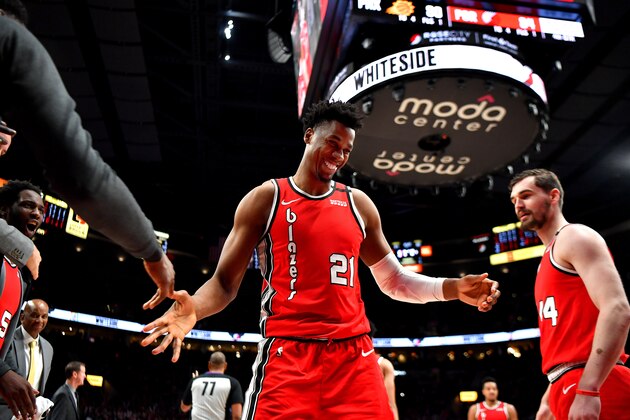 PORTLAND, OREGON - MARCH 10: Hassan Whiteside #21 of the Portland Trail Blazers congratulated by teammates after getting fouled during the second half of the game against the Phoenix Suns at the Moda Center on March 10, 2020 in Portland, Oregon. The Portland Trail Blazers topped the Phoenix Suns, 121-105. NOTE TO USER: User expressly acknowledges and agrees that, by downloading and or using this photograph, User is consenting to the terms and conditions of the Getty Images License Agreement. (Photo by Alika Jenner/Getty Images)