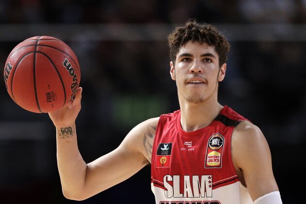 FILE - In this Nov. 17, 2019, file photo, LaMelo Ball of the Illawarra Hawks carries the ball up during their game against the Sydney Kings in the Australian Basketball League in Sydney.  LaMelo Ball's bone bruise on his left foot is expected to keep him out of the Illawarra Hawks lineup for the remainder of the National Basketball League season in Australia. The 18-year-old American, who joined Illawarra as part of the NBL's Next Stars program, is expected to be a first-round pick in this year's NBA draft.(AP Photo/Rick Rycroft, File)