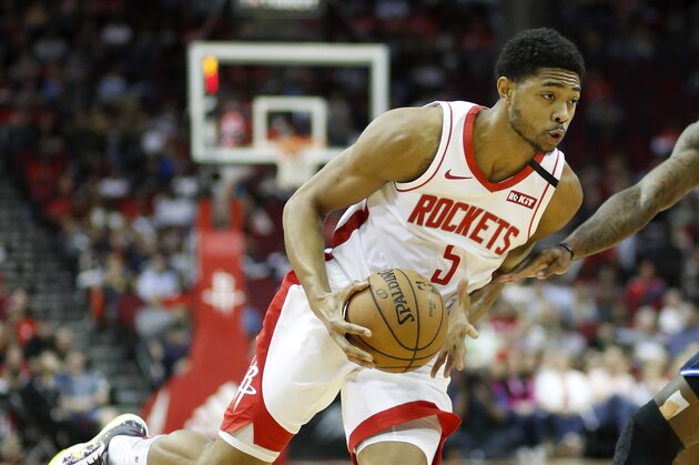 HOUSTON, TEXAS - MARCH 08: Bruno Caboclo #5 of the Houston Rockets drives to the basket while defended by Gary Clark #12 of the Orlando Magic in the second half at Toyota Center on March 08, 2020 in Houston, Texas.  NOTE TO USER: User expressly acknowledges and agrees that, by downloading and or using this photograph, User is consenting to the terms and conditions of the Getty Images License Agreement. (Photo by Tim Warner/Getty Images)