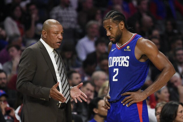 Los Angeles Clippers forward Kawhi Leonard, right, speaks with head coach Doc Rivers after being taken out of the game during the second half of an NBA basketball game against the New Orleans Pelicans in Los Angeles, Sunday, Nov. 24, 2019. The Clippers won 134-109. (AP Photo/Kelvin Kuo)