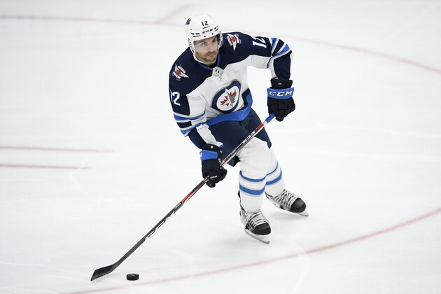 Winnipeg Jets defenseman Dylan DeMelo (12) skates with the puck during the third period of an NHL hockey game against the Washington Capitals, Tuesday, Feb. 25, 2020, in Washington. The Capitals won 4-3 in shootout. (AP Photo/Nick Wass)