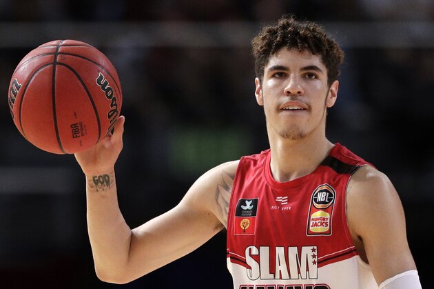 FILE - In this Nov. 17, 2019, file photo, LaMelo Ball of the Illawarra Hawks carries the ball up during their game against the Sydney Kings in the Australian Basketball League in Sydney. LaMelo Ball's bone bruise on his left foot is expected to keep him out of the Illawarra Hawks lineup for the remainder of the National Basketball League season in Australia. The 18-year-old American, who joined Illawarra as part of the NBL's Next Stars program, is expected to be a first-round pick in this year's NBA draft.(AP Photo/Rick Rycroft, File) FILE - In this Nov. 17, 2019, file photo, LaMelo Ball of the Illawarra Hawks carries the ball up during their game against the Sydney Kings in the Australian Basketball League in Sydney. LaMelo Ball's bone bruise on his left foot is expected to keep him out of the Illawarra Hawks lineup for the remainder of the National Basketball League season in Australia. The 18-year-old American, who joined Illawarra as part of the NBL's Next Stars program, is expected to be a first-round pick in this year's NBA draft.(AP Photo/Rick Rycroft, File)