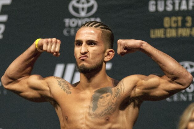 UFC fighter Sergio Pettis flexes his muscles during the weigh in for UFC 192, Friday, Oct. 2, 2015 in Houston. (AP Photo/Juan DeLeon)