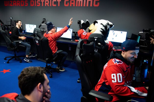 Washington Capitals esports player John Casagranda of Alaska reacts while playing a hockey video game on February 27, 2020, in Washington, DC. - In a windowless room in downtown Washington, the city's most promising new basketballers are honing their skills and readying to compete against adversaries they sometimes don't even meet. There are no hoops or balls in the practice room of Wizards District Gaming, just video monitors and consoles loaded with NBA 2K20, the basketball simulation that the team's eSports athletes use to compete with adversaries from across the United States. Video games are now the largest entertainment industry in the world, and innovations like livestreaming have made eSports a global phenomenon. The largest competitions have had tens of millions of viewers watching competitors battle for millions of dollars in prizes. (Photo by Brendan Smialowski / AFP) (Photo by BRENDAN SMIALOWSKI/AFP via Getty Images)