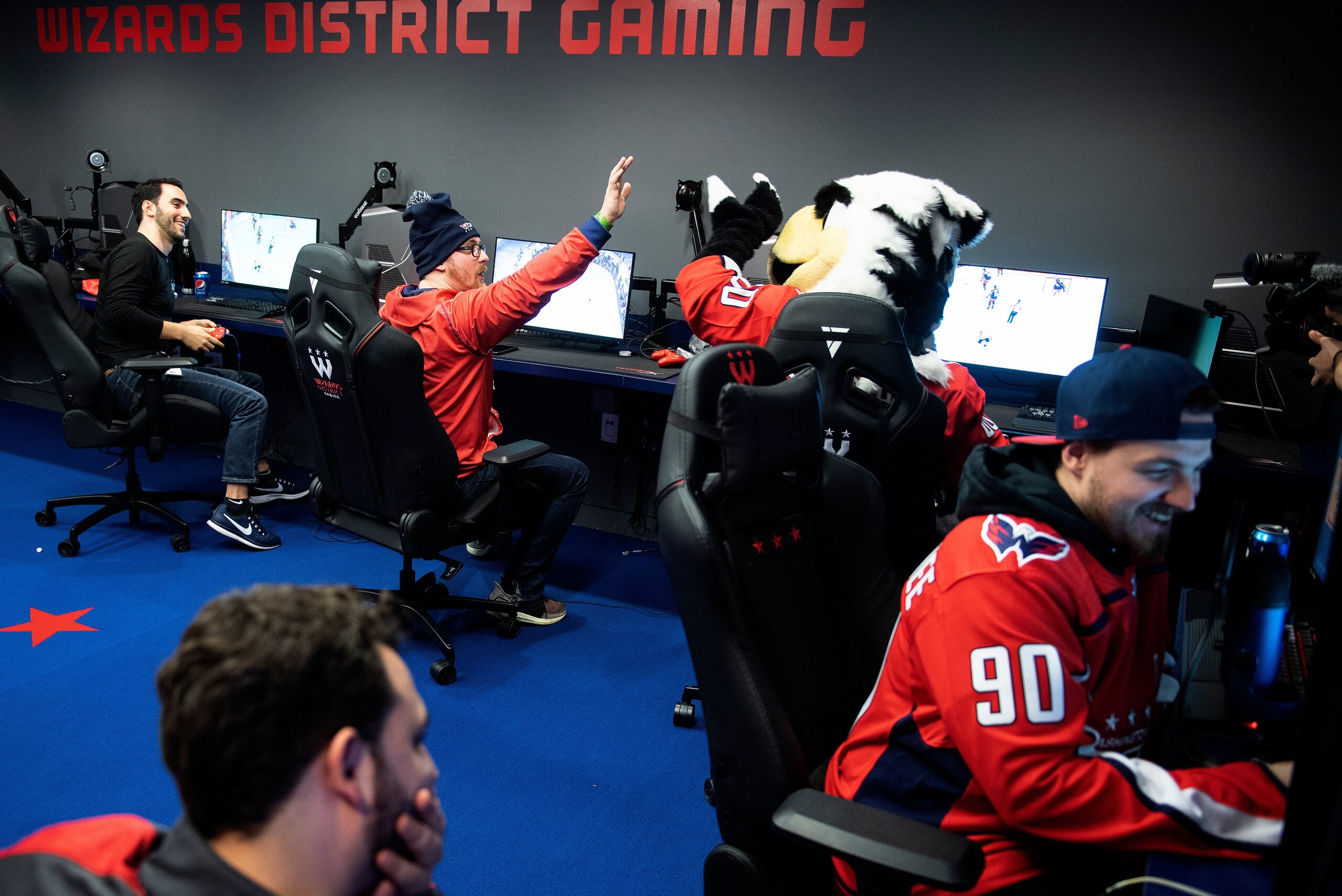 Washington Capitals esports player John Casagranda of Alaska reacts while playing a hockey video game on February 27, 2020, in Washington, DC. - In a windowless room in downtown Washington, the city's most promising new basketballers are honing their skills and readying to compete against adversaries they sometimes don't even meet. There are no hoops or balls in the practice room of Wizards District Gaming, just video monitors and consoles loaded with NBA 2K20, the basketball simulation that the team's eSports athletes use to compete with adversaries from across the United States. Video games are now the largest entertainment industry in the world, and innovations like livestreaming have made eSports a global phenomenon. The largest competitions have had tens of millions of viewers watching competitors battle for millions of dollars in prizes. (Photo by Brendan Smialowski / AFP) (Photo by BRENDAN SMIALOWSKI/AFP via Getty Images)
