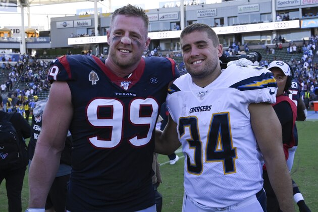 Houston Texans defensive end J.J. Watt, left, greets his brother Los Angeles Chargers fullback Derek Watt after an NFL football game Sunday, Sept. 22, 2019, in Carson, Calif. The Texans won 27-20. (AP Photo/Mark J. Terrill)