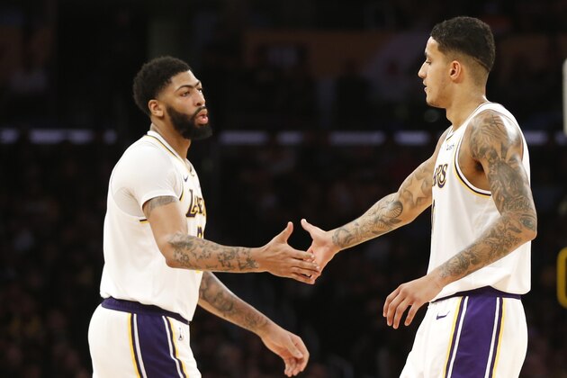 LOS ANGELES, CALIFORNIA - DECEMBER 08:  Kyle Kuzma #0 and Anthony Davis #3 of the Los Angeles Lakers high-fice during the second half against the Minnesota Timberwolves at Staples Center on December 08, 2019 in Los Angeles, California. NOTE TO USER: User expressly acknowledges and agrees that, by downloading and or using this photograph, User is consenting to the terms and conditions of the Getty Images License Agreement. (Photo by Katharine Lotze/Getty Images)