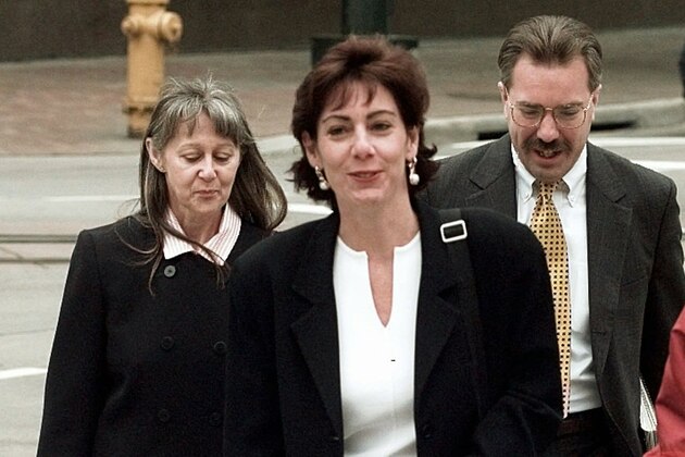 Steven Burmeister, right center, an FBI chemist, and U.S attorney Beth Wilkinson, left center, arrive at the federal courthouse in Denver on Monday, May 19, 1997, where Burmeister testified  at the trial of Oklahoma City bombing suspect Timothy McVeigh. They are being escorted by an FBI agent, far right, and an unidentified woman, far left, with the Justice Department.  Cross examination of Burmeister by McVeigh's defense team is scheduled to continue Tuesday. (AP Photo/Ed Andrieski)