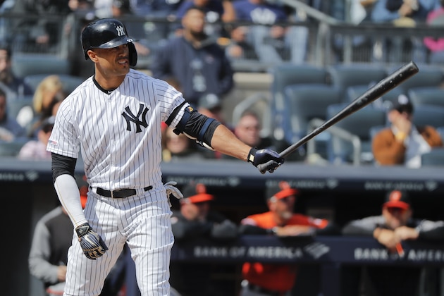 FILE - In this Saturday, March 30, 2019 file photo, New York Yankees right fielder Giancarlo Stanton waits for the pitch against the Baltimore Orioles during the fourth inning of a baseball game in New York. Giancarlo Stanton wants to return from his knee injury in time to fine-tune that powerful swing for October. Sidelined nearly all season, the New York Yankees slugger is hitting indoors and throwing as he rehabs from a sprained right knee that's been slow to heal since he got hurt June 25. (AP Photo/Julie Jacobson, File)