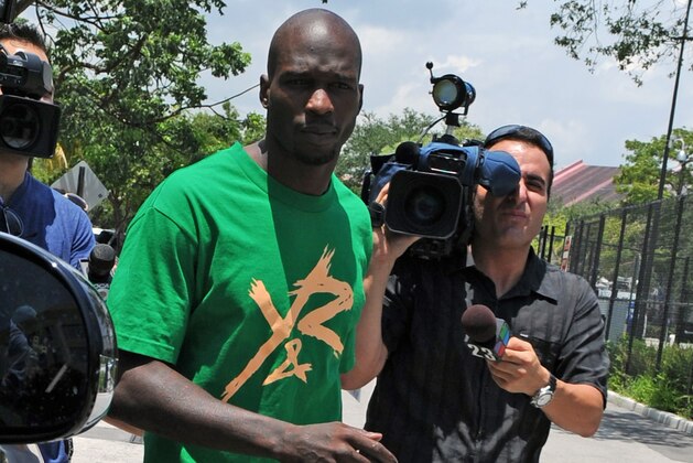 FILE - In this Aug. 12, 2012 file photo, Chad Johnson, center, leaves Broward County Jail in Fort Lauderdale, Fla. A contrite Johnson apologized Monday, June 17, 2013, for disrespecting a judge when the former NFL star slapped his attorney on the backside in court a week earlier, and his immediate release from jail was ordered. (Photo by Jeff Daly/Invision/AP, File)