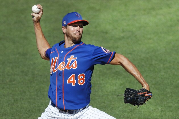 FILE - In this July 9, 2020, file photo, New York Mets starting pitcher Jacob deGrom winds up while delivering during a simulated baseball game, part of the Mets summer training camp workout, at Citi Field in New York. Pete Alonso at the plate. Jacob deGrom on the mound. And a healthy Yoenis Céspedes pegged conveniently for designated hitter. There’s no question the New York Mets have reasons to believe this pandemic-shortened season is perfect for them -- even without injured starter Noah Syndergaard. All they need to do is pick right up where they left off last year.(AP Photo/Kathy Willens, File)