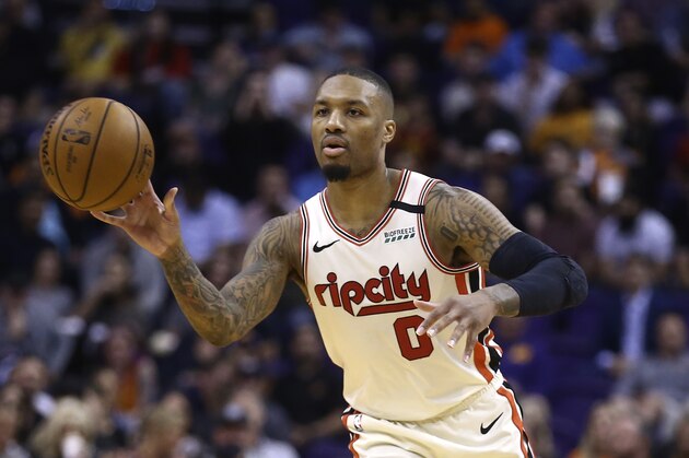 Portland Trail Blazers guard Damian Lillard passes the ball against the Phoenix Suns during the first half of an NBA basketball game Friday, March 6, 2020, in Phoenix. The Suns defeated the Trail Blazers 127-117. (AP Photo/Ross D. Franklin)