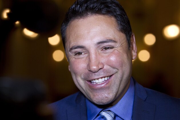 FILE - In this June 26, 2014 file photo, boxer Oscar De La Hoya talks with reporters in Sacramento, Calif. Of all the things Donald Trump has been called on the campaign trail, this one might sting the most: golf cheat. De La Hoya says that's what he saw on the links when Trump joined up with his group at Trump National Golf Club in Los Angeles two years ago. Trump, he said, cheated not once but twice in the space of two holes. (AP Photo/Steve Yeater, File) FILE - In this June 26, 2014 file photo, boxer Oscar De La Hoya talks with reporters in Sacramento, Calif. Of all the things Donald Trump has been called on the campaign trail, this one might sting the most: golf cheat. De La Hoya says that's what he saw on the links when Trump joined up with his group at Trump National Golf Club in Los Angeles two years ago. Trump, he said, cheated not once but twice in the space of two holes. (AP Photo/Steve Yeater, File)