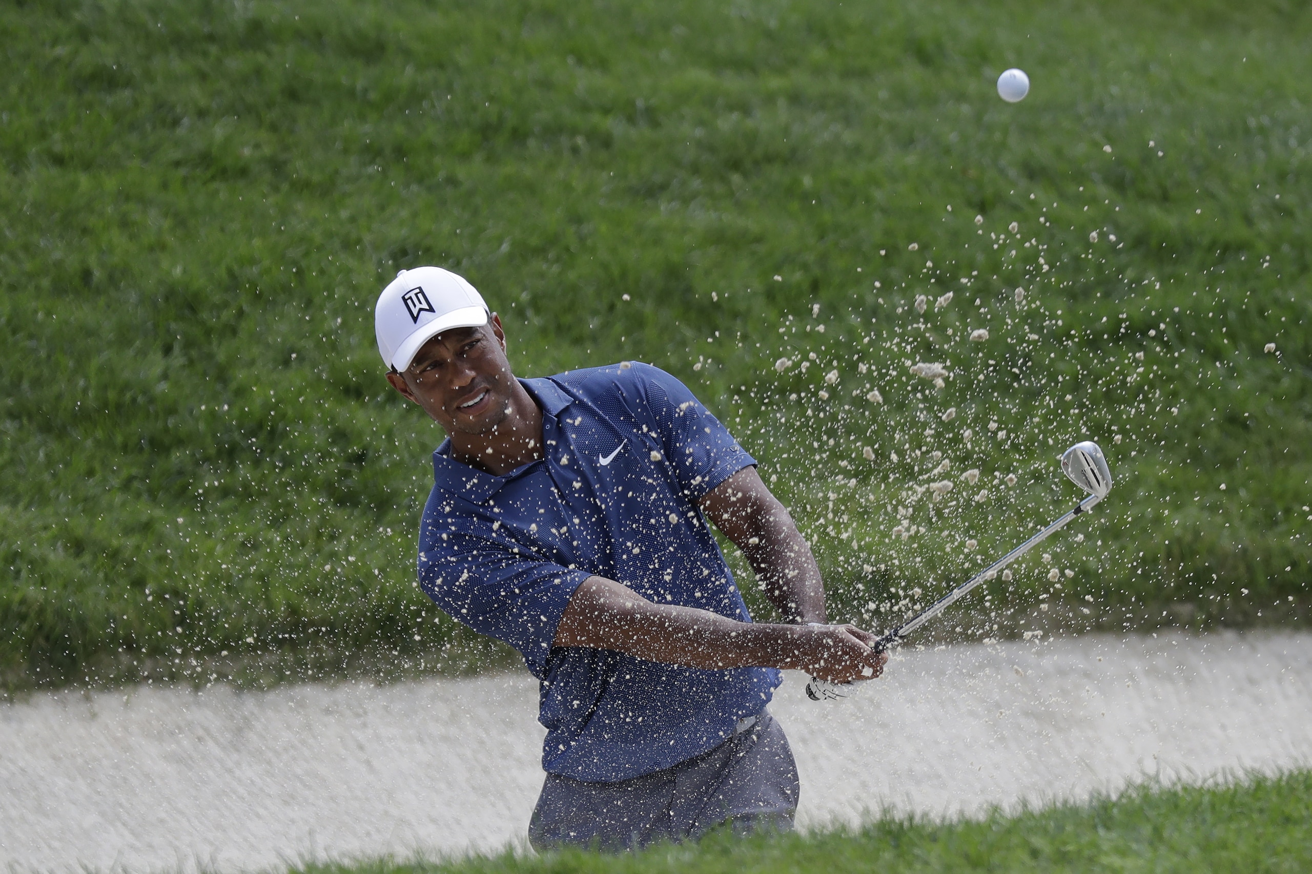 Tiger Woods hits from a bunker toward the fourth hole during the second round of the Memorial golf tournament, Friday, July 17, 2020, in Dublin, Ohio. (AP Photo/Darron Cummings)