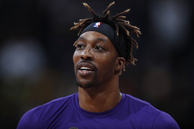 FILE - In this Feb. 12, 2020, file photo, Los Angeles Lakers center Dwight Howard looks on in the first half of an NBA basketball game against the Denver Nuggets in Denver. The mother of Howard's 6-year-old son died nearly six weeks ago due to an epileptic seizure, the Lakers center says. Howard has spent his hiatus from basketball dealing with the difficult task of explaining Melissa Rios' death to their son, but also grateful for the chance to heal from the loss outside the daily grind of the NBA schedule. (AP Photo/David Zalubowski, File)