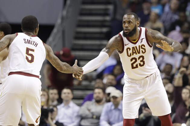 Cleveland Cavaliers' LeBron James (23) is congratulated by Cleveland Cavaliers' JR Smith (5) during the second half of an NBA basketball game against the Charlotte Hornets in Charlotte, N.C., Wednesday, March 28, 2018. (AP Photo/Chuck Burton)
