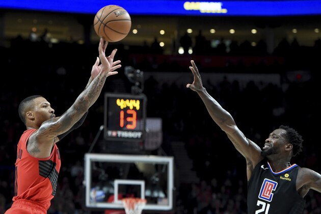 Portland Trail Blazers guard Damian Lillard, left, hits a shot over Los Angeles Clippers guard Patrick Beverley during the second half of an NBA basketball game in Portland, Ore., Thursday, Nov. 8, 2018. The Blazers won 116-105. (AP Photo/Steve Dykes)