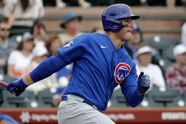 Chicago Cubs' Anthony Rizzo follows through on a base hit against the San Francisco Giants during the first inning of a spring training baseball game Tuesday, March 10, 2020, in Scottsdale, Ariz. (AP Photo/Matt York)