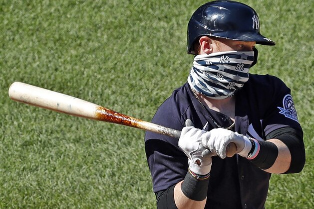 New York Yankees' Clint Frazier wears a face mask while batting during an intrasquad game in baseball summer training camp Sunday, July 12, 2020, at Yankee Stadium in New York. (AP Photo/Kathy Willens)