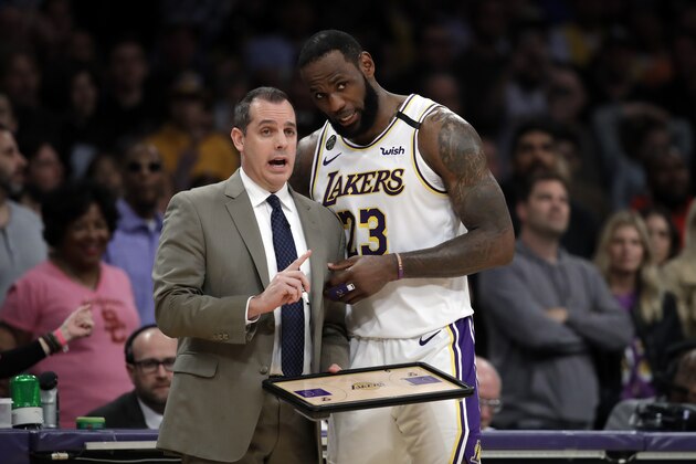 Los Angeles Lakers head coach Frank Vogel, left, talks to LeBron James during the second half of an NBA basketball game against the Boston Celtics Sunday, Feb. 23, 2020, in Los Angeles. (AP Photo/Marcio Jose Sanchez)