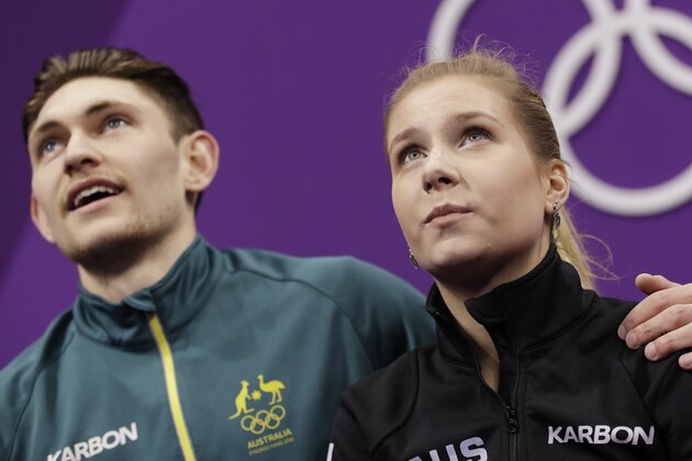 Ekaterina Alexandrovskaya and Harley Windsor of Australia watch as their scores are posted after their performance in the pair figure skating short program in the Gangneung Ice Arena at the 2018 Winter Olympics in Gangneung, South Korea, Wednesday, Feb. 14, 2018. (AP Photo/Bernat Armangue)